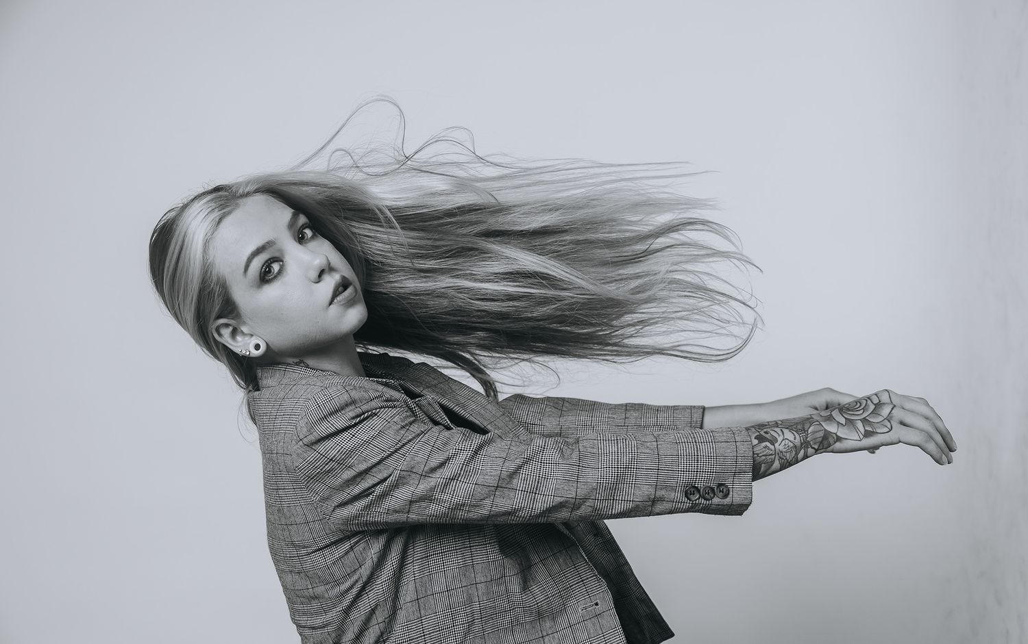 Small boy on stairs smiling wearing a beanie